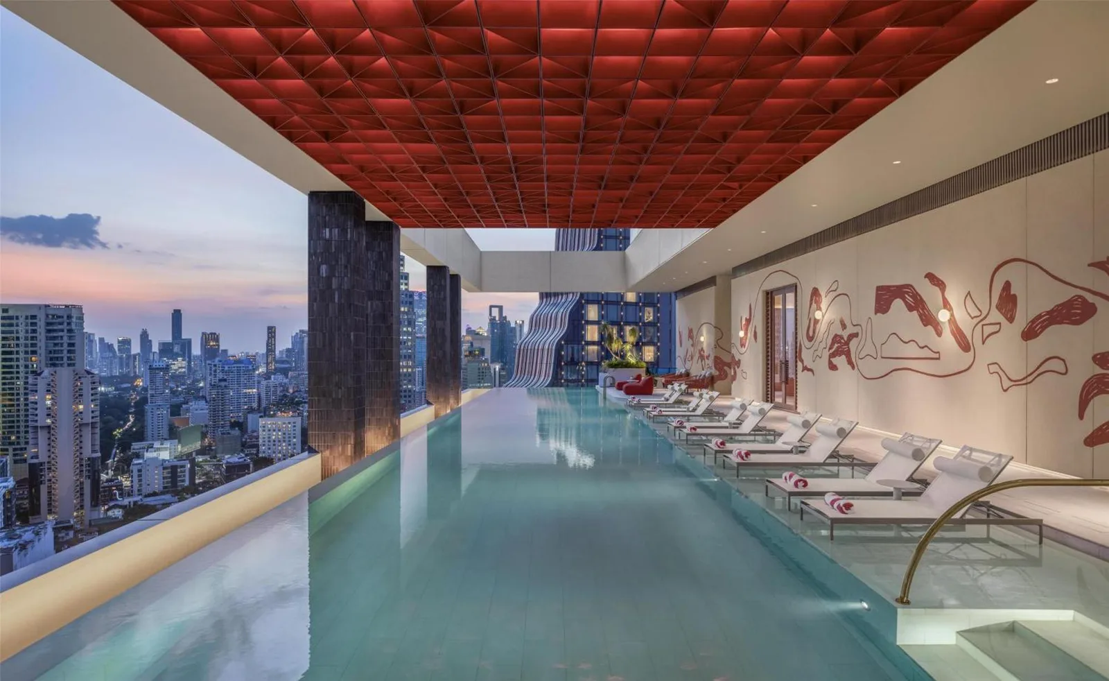 Infinity rooftop pool at Kromo Bangkok, Curio Collection By Hilton with skyline view