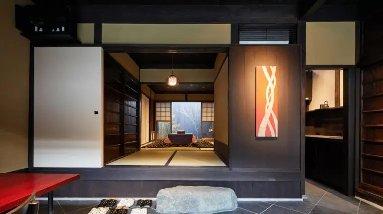 a bedroom with two beds and a window at Kyoto Urushiro Wakasaya in Kyoto