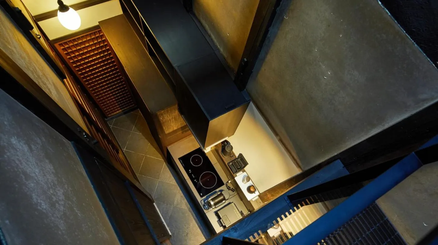 a spiral staircase in a building with a window at Kyoto Urushiro Wakasaya in Kyoto