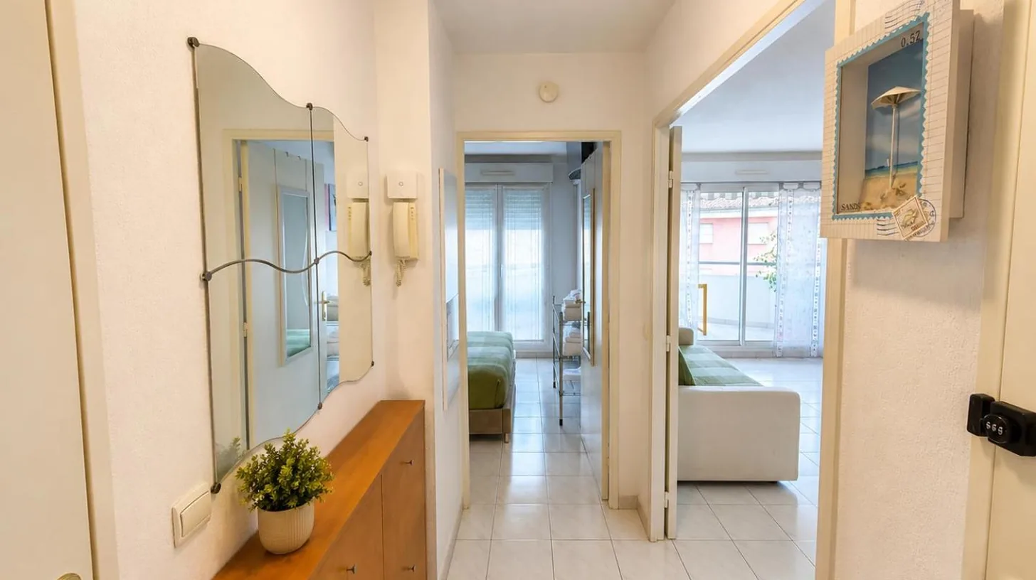 a hallway with a mirror and a living room at La Terrasse Bleue-Parking couvert-2 min plage-Juan Les Pins in Antibes