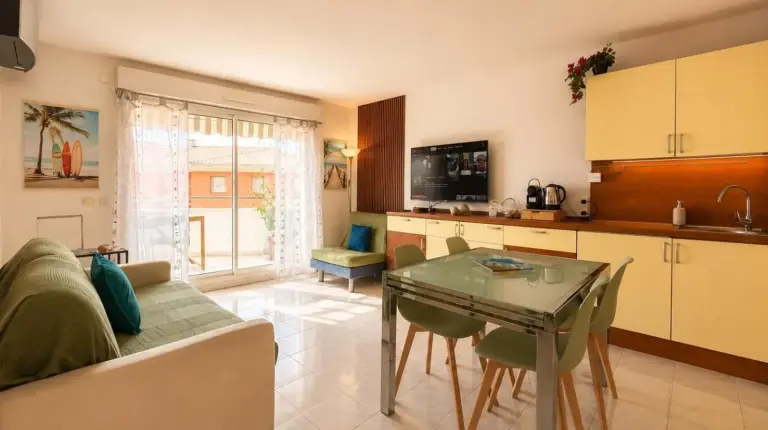 a living room with a couch and a table at La Terrasse Bleue-Parking couvert-2 min plage-Juan Les Pins in Antibes