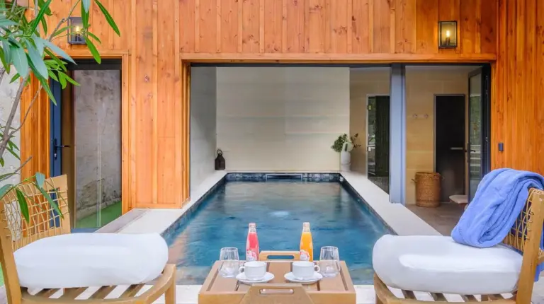 two chairs and a table next to a swimming pool at Le Boutique Hotel & Spa in Bordeaux