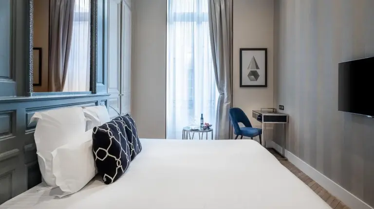 a hallway with two doors and a mirror at Le Boutique Hotel & Spa in Bordeaux