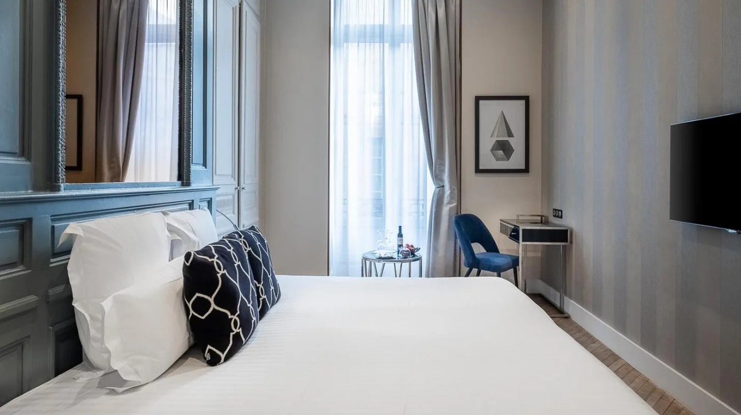 a hallway with two doors and a mirror at Le Boutique Hotel & Spa in Bordeaux