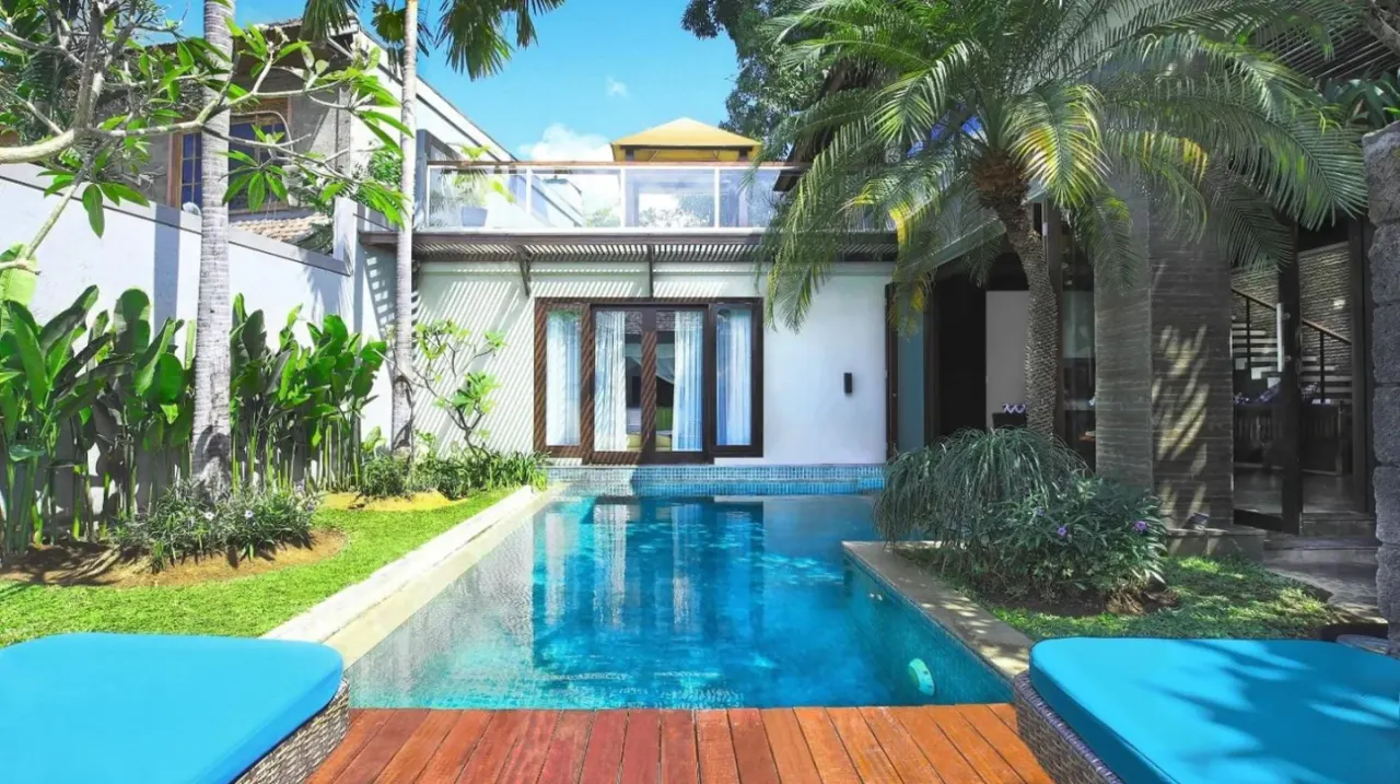 a swimming pool in the backyard of a house at Le Jardin Villas Seminyak in Seminyak