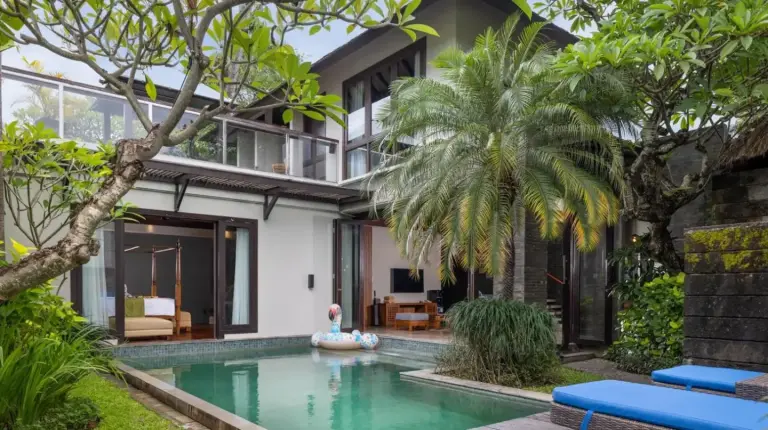 an external view of a villa with a swimming pool at Le Jardin Villas Seminyak in Seminyak