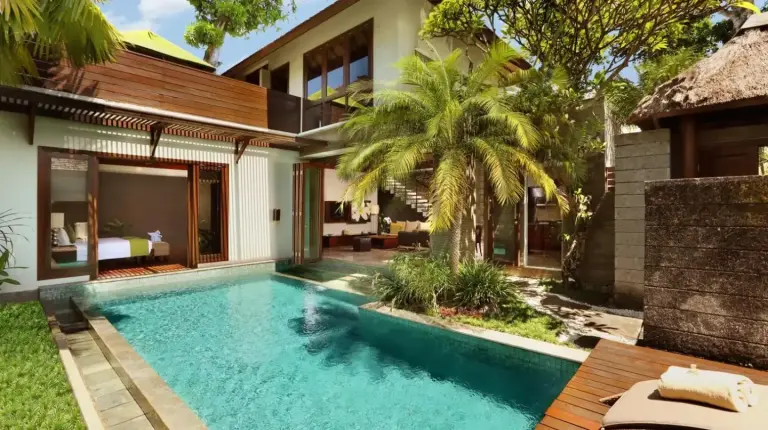a swimming pool in the backyard of a villa at Le Jardin Villas Seminyak in Seminyak