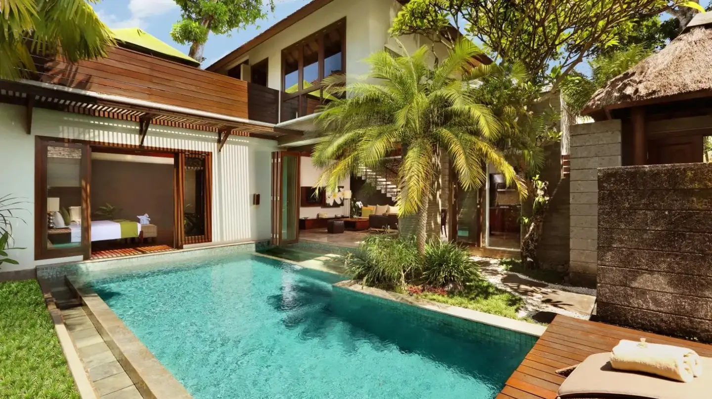 a swimming pool in the backyard of a villa at Le Jardin Villas Seminyak in Seminyak
