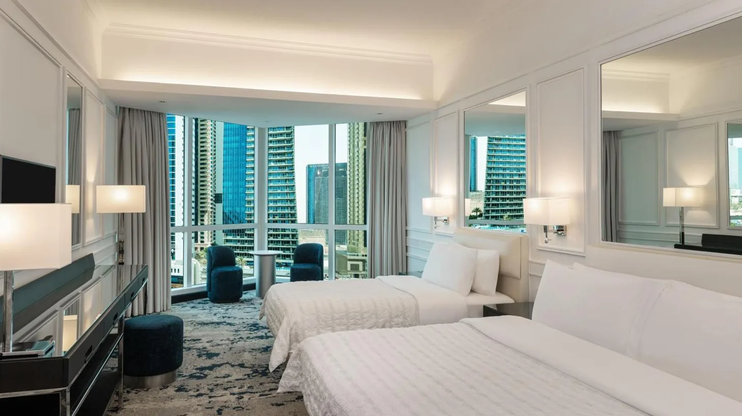 a bedroom with a bed and a painting on the wall at Le Meridien Mina Seyahi Beach Resort & Waterpark in Dubai
