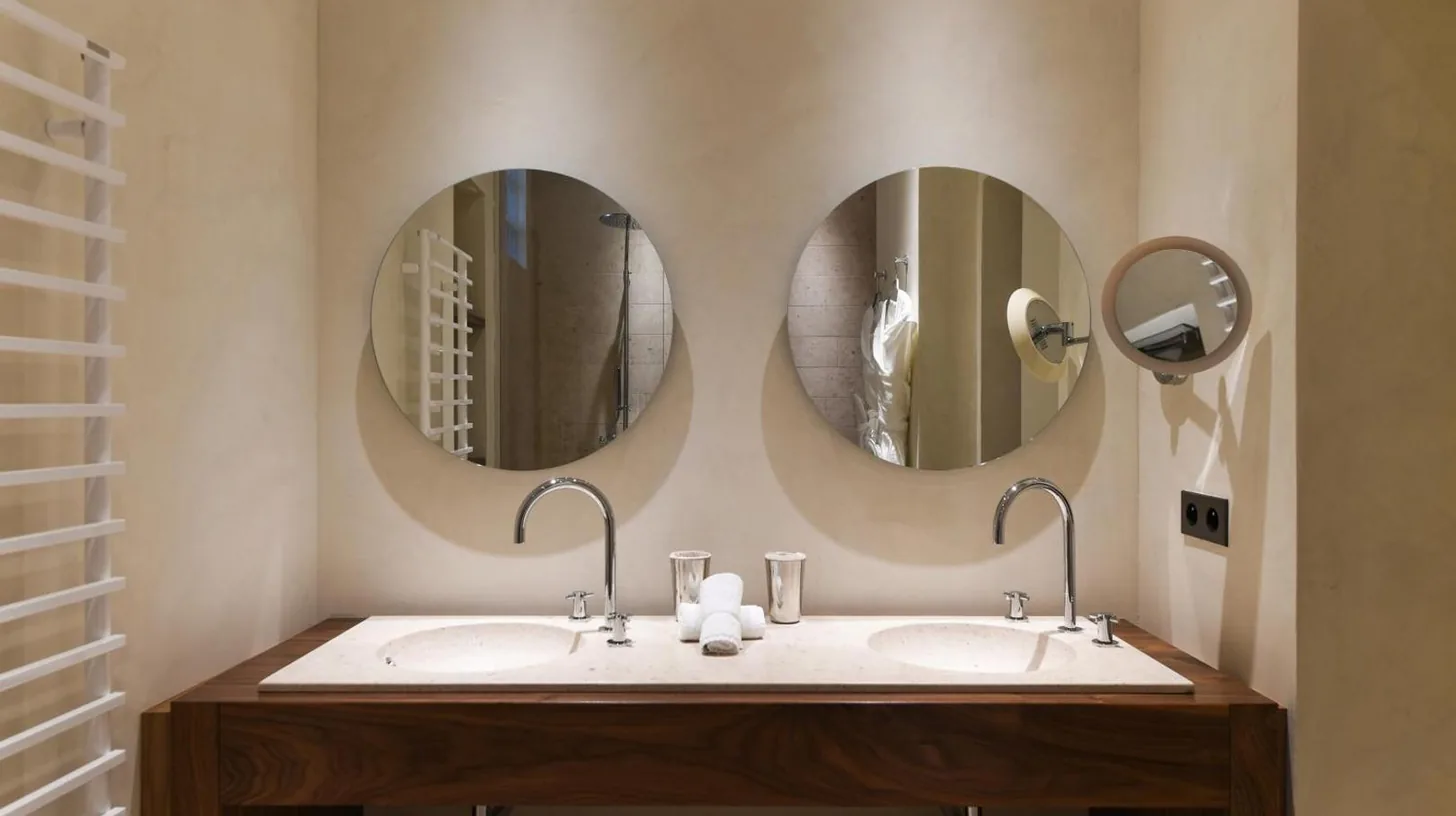 a bathroom with two sinks and two mirrors at Le Petit Nice - Passedat in Marseille