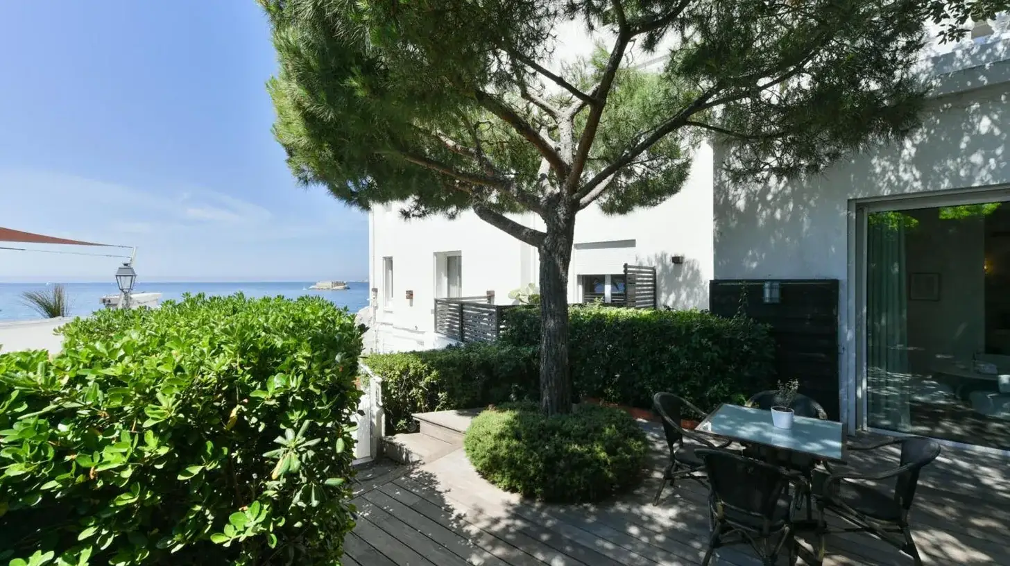 a patio with a table and a tree at Le Petit Nice - Passedat in Marseille
