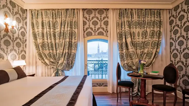 a hotel room with a bed and a window at Londra Palace Venezia in Venice