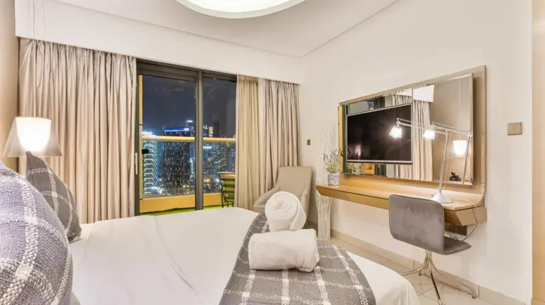 a living room with a couch and a table at Luxury 1BR with Burj Khalifa View 5-Star Amenities & Valet Parking in Dubai