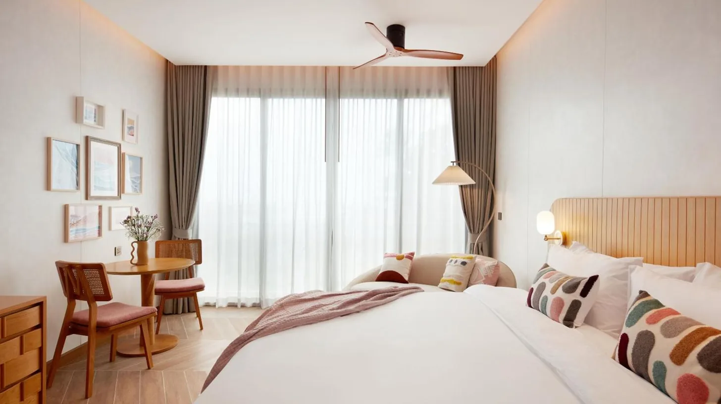 a hotel room with a bed and a table at Marasca Samui - Small Luxury Hotels of the World in Chaweng