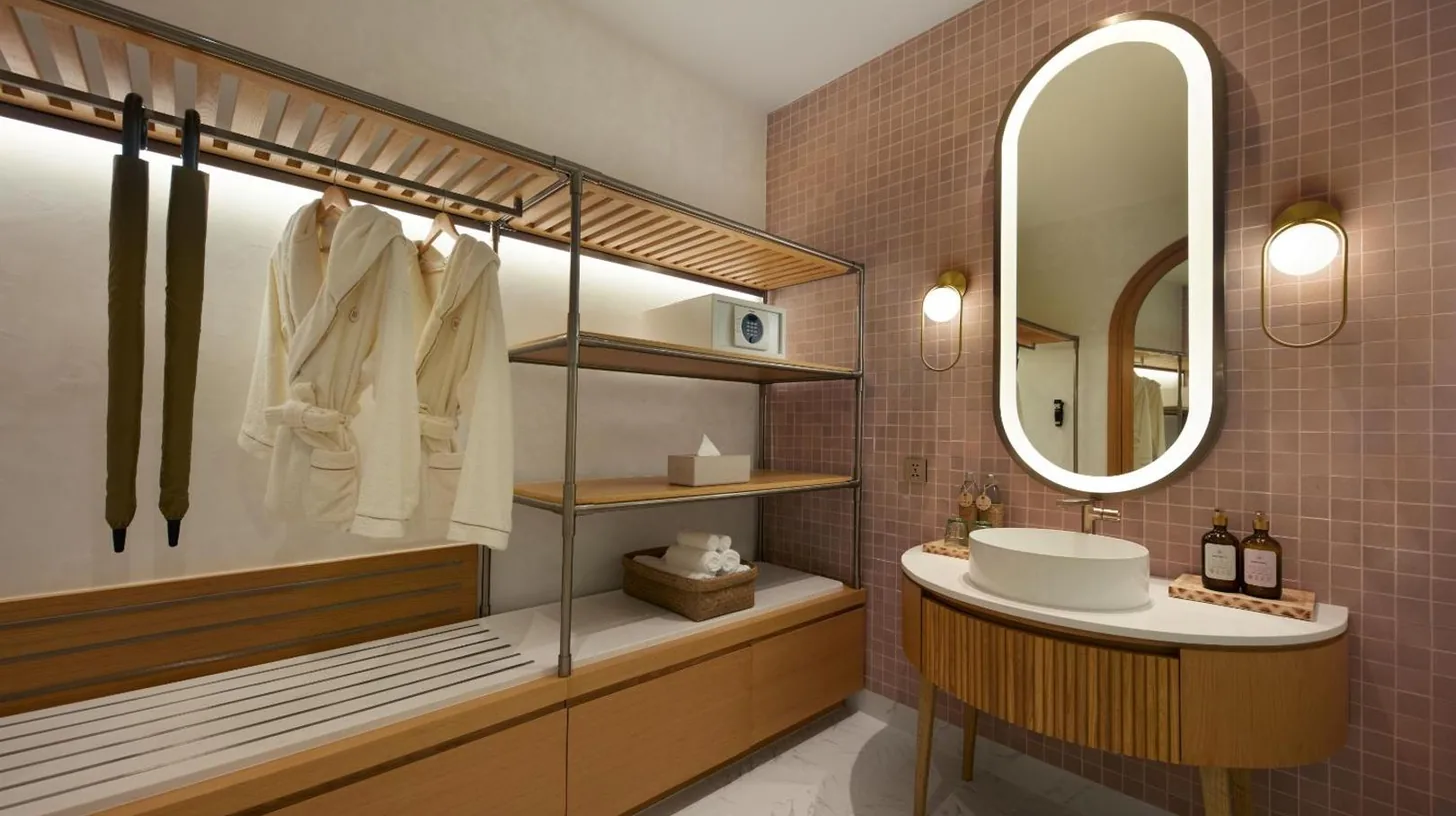 a bathroom with a sink and a mirror at Marasca Samui - Small Luxury Hotels of the World in Chaweng