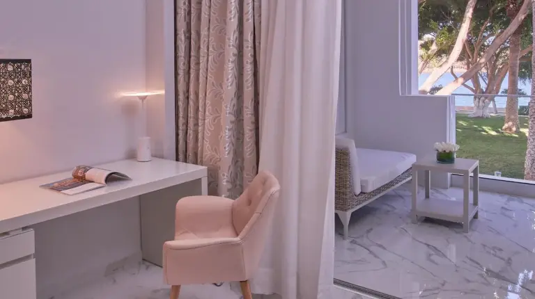 a white room with a desk and a chair and a window at Marchica Lagoon Resort in Nador