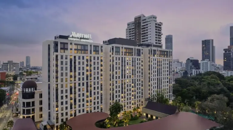a large white building with a city in the background at Marriott Executive Apartments