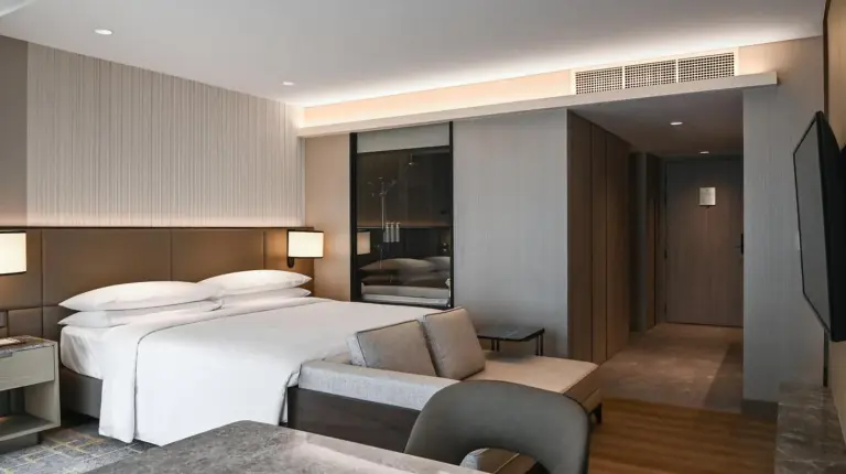 a kitchen with wooden cabinets and a living room at Marriott Executive Apartments