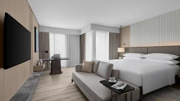 a hotel room with a large bed and a chair at Marriott Executive Apartments
