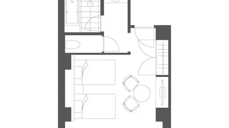 a hotel room with a bed and a table and chairs at Marufukuro in Kyoto