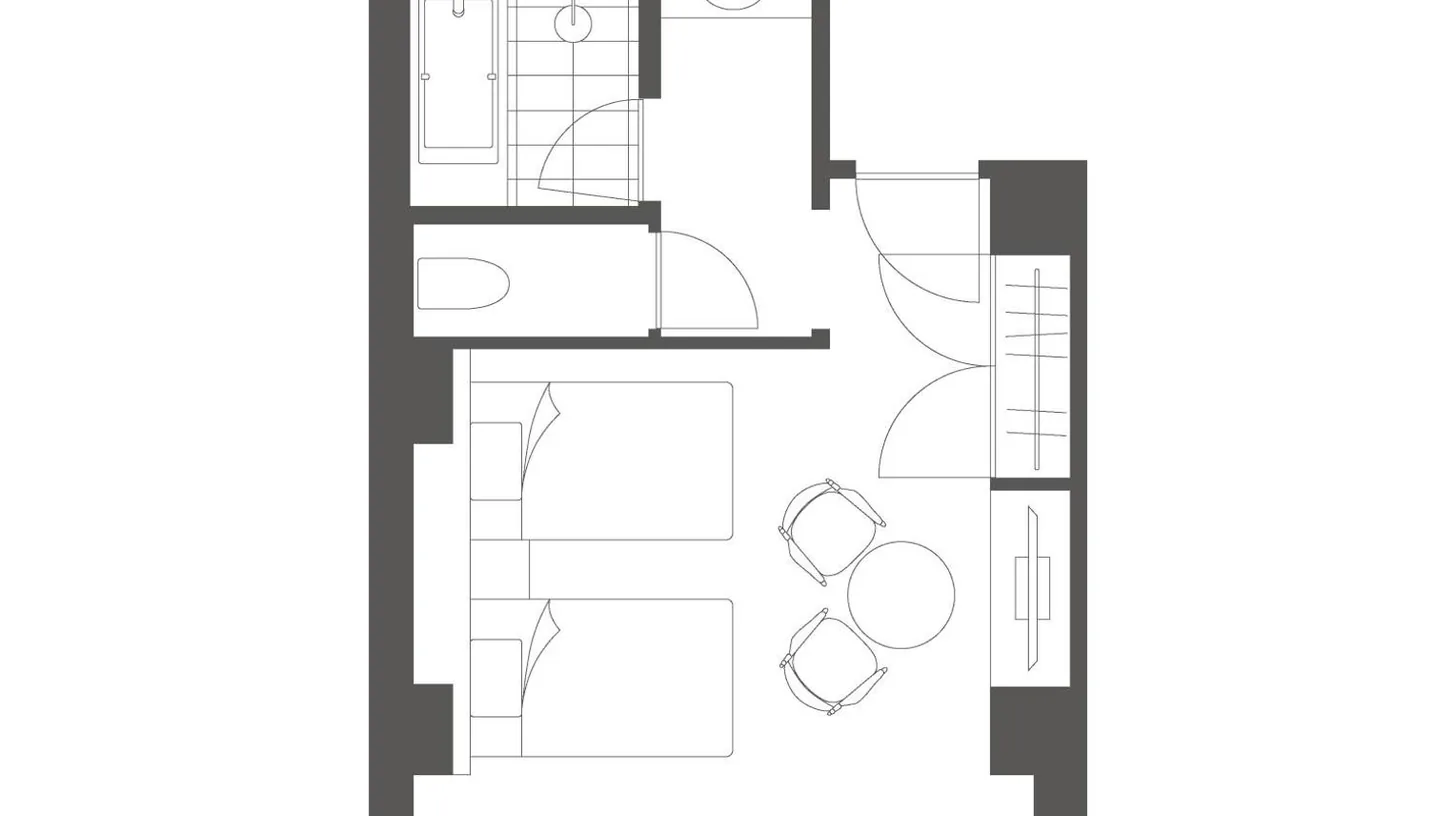 a hotel room with a bed and a table and chairs at Marufukuro in Kyoto
