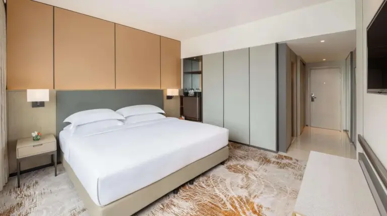 a hotel room with two beds and a large window at Millennium Hilton Bangkok in Bangkok