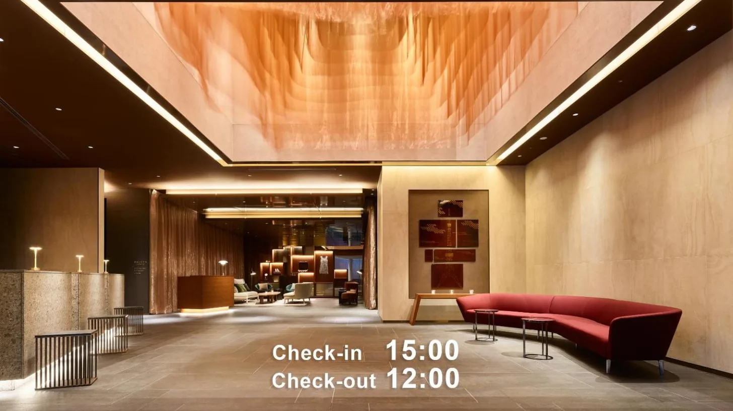 a lobby with a red couch and a table at Mitsui Garden Hotel Roppongi Tokyo Premier in Tokyo