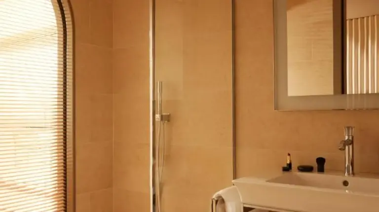 a bathroom with a sink and a shower at Mondrian Bordeaux Les Carmes in Bordeaux