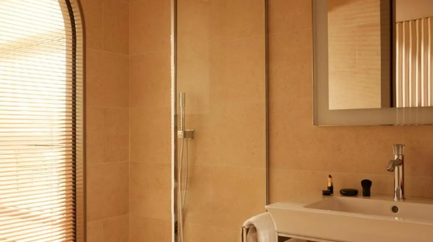 a bathroom with a sink and a shower at Mondrian Bordeaux Les Carmes in Bordeaux