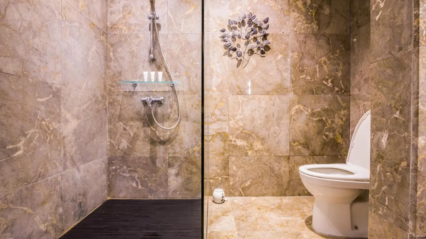 a bathroom with three sinks and a mirror at Montigo Resorts Seminyak in Seminyak