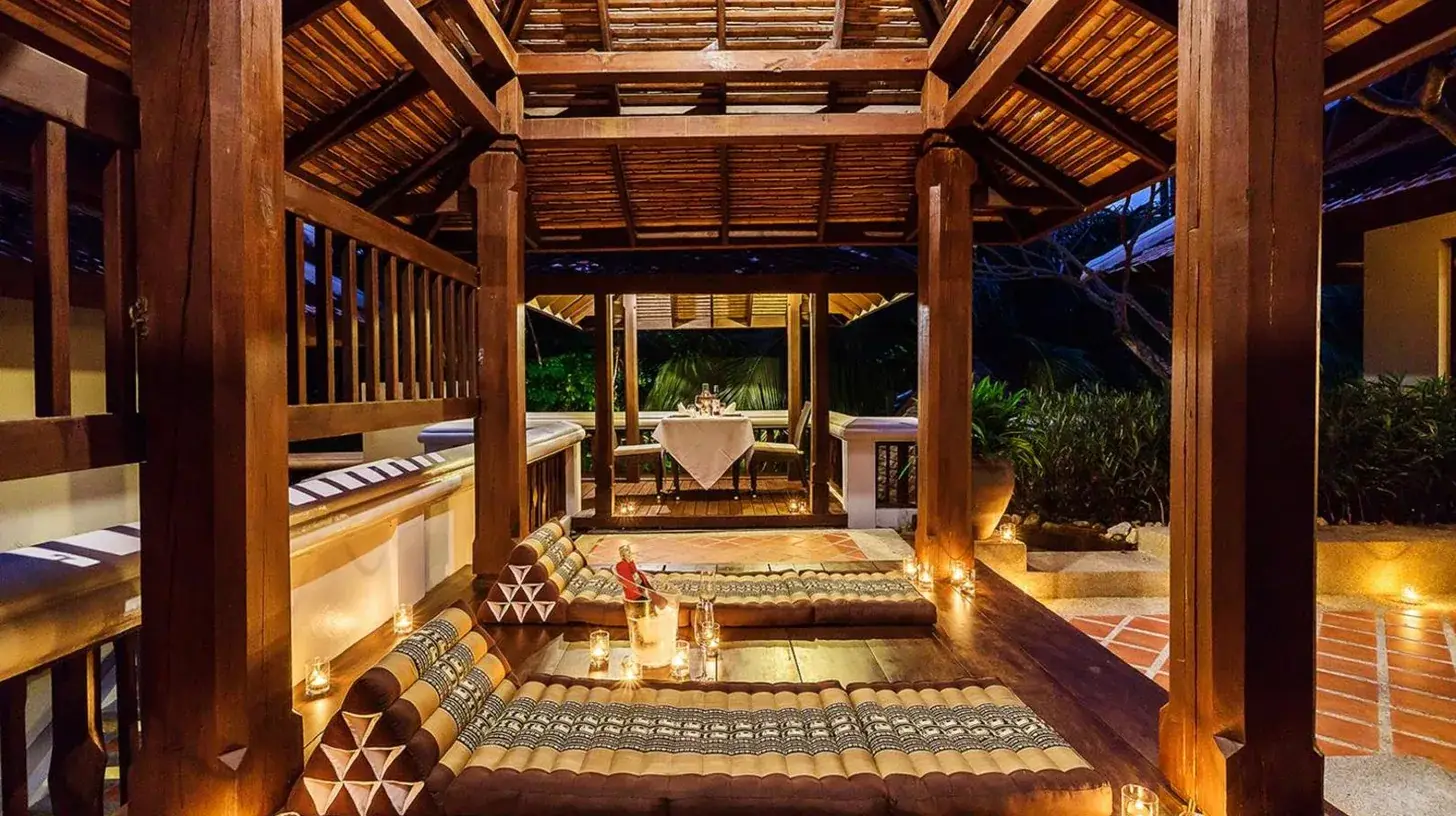 an outdoor patio with a wooden pergola at Muang Samui Spa Resort in Chaweng