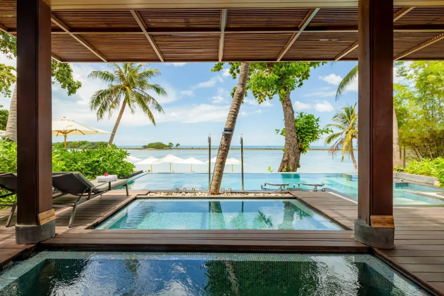 Muang Samui Spa Resort infinity pool view with palm trees and ocean