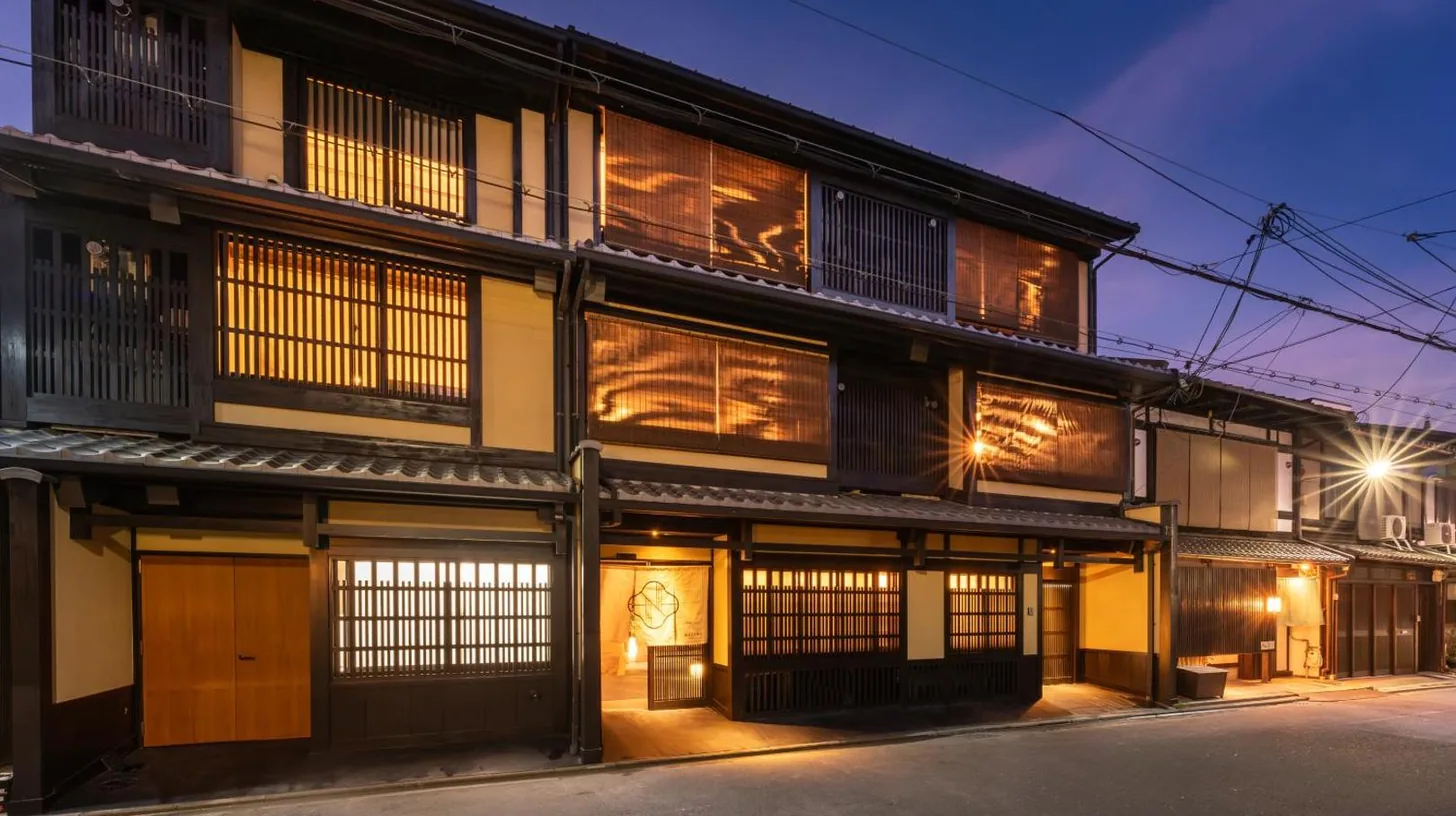 an old building with wooden doors and windows at night at Nazuna Kyoto Nishi Honganji in Kyoto