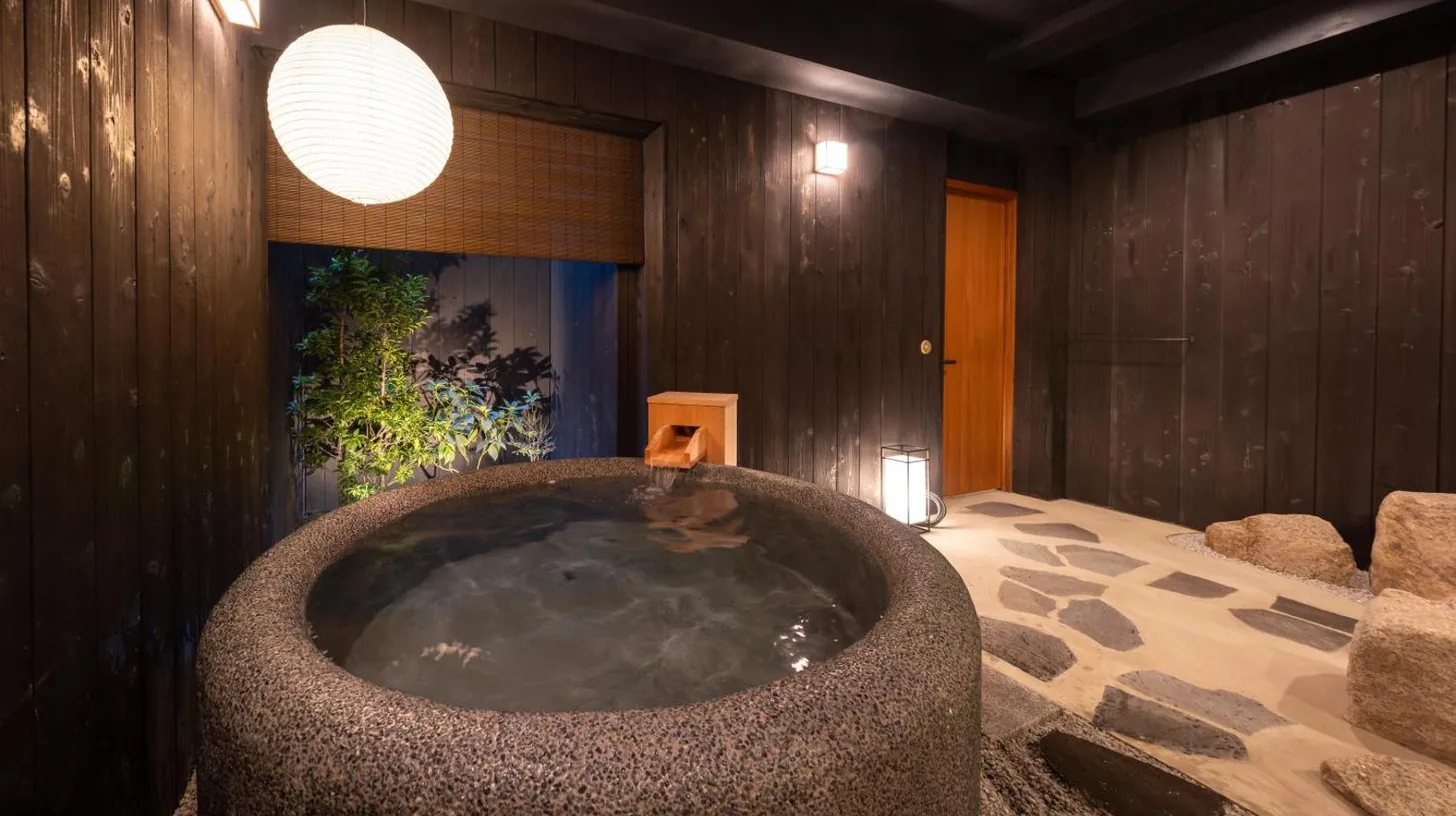 a large bath tub in a room with at Nazuna Kyoto Nishi Honganji in Kyoto