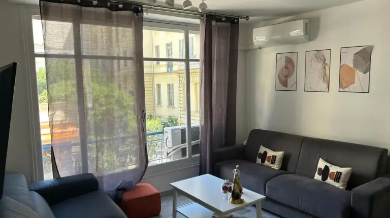 a living room with a couch and a table at New central nice sea down town in Nice
