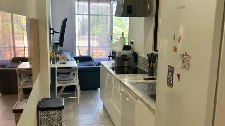 a kitchen with a white refrigerator and a table at New central nice sea down town in Nice