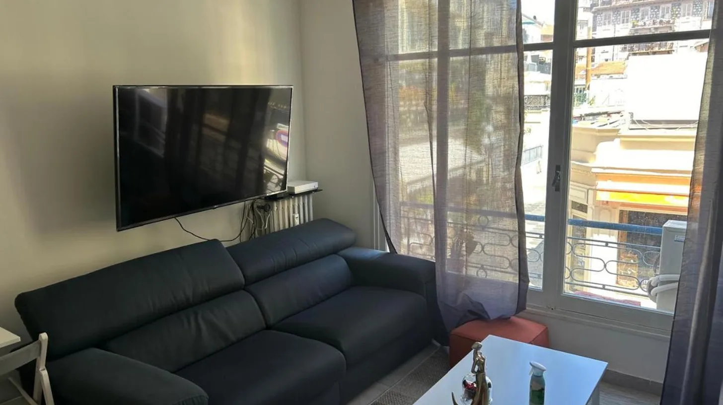 a living room with a couch and a tv at New central nice sea down town in Nice
