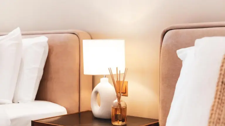a lamp on a table next to two beds at New Fairmont Residence with private beach on Palm Jumeirah in Dubai