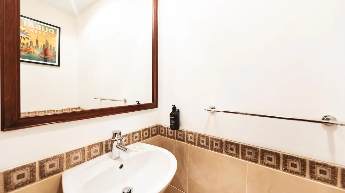 a bathroom with a sink and a mirror at New Fairmont Residence with private beach on Palm Jumeirah in Dubai
