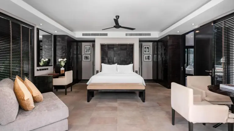 a bedroom with a bed and a living room at Nikki Beach Resort & Spa Koh Samui in Lipa Noi