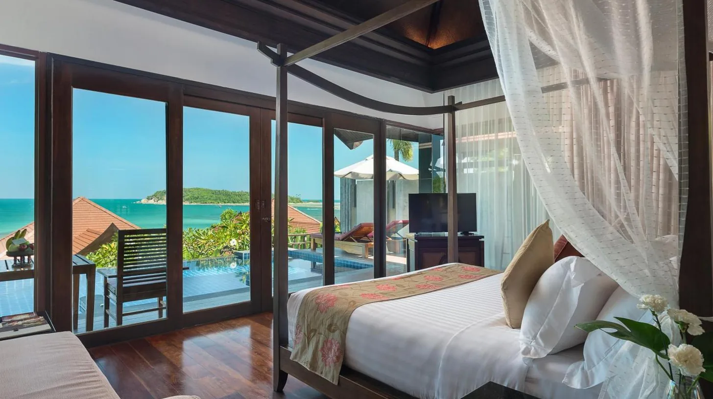 a bedroom with a bed and a view of the ocean at Nora Buri Resort & Spa in Chaweng