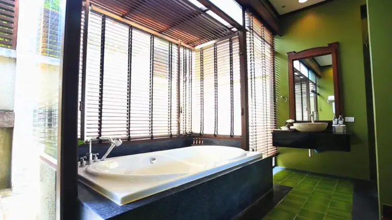 a bathroom with a tub and a large window at Nora Buri Resort & Spa in Chaweng