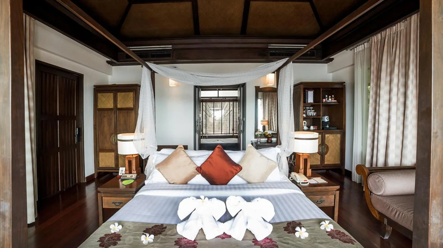a bedroom with a bed with two teddy bears on it at Nora Buri Resort & Spa in Chaweng