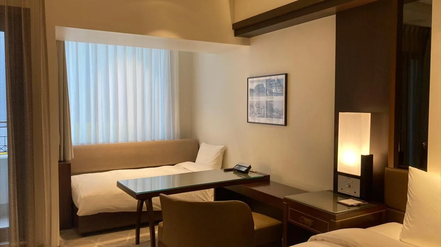 a hotel room with a desk and a bed at Okinawa EXES Naha in Naha