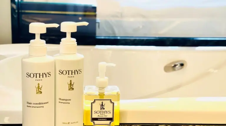 a bathroom with two bottles of soap and a sink at Okinawa EXES Naha in Naha