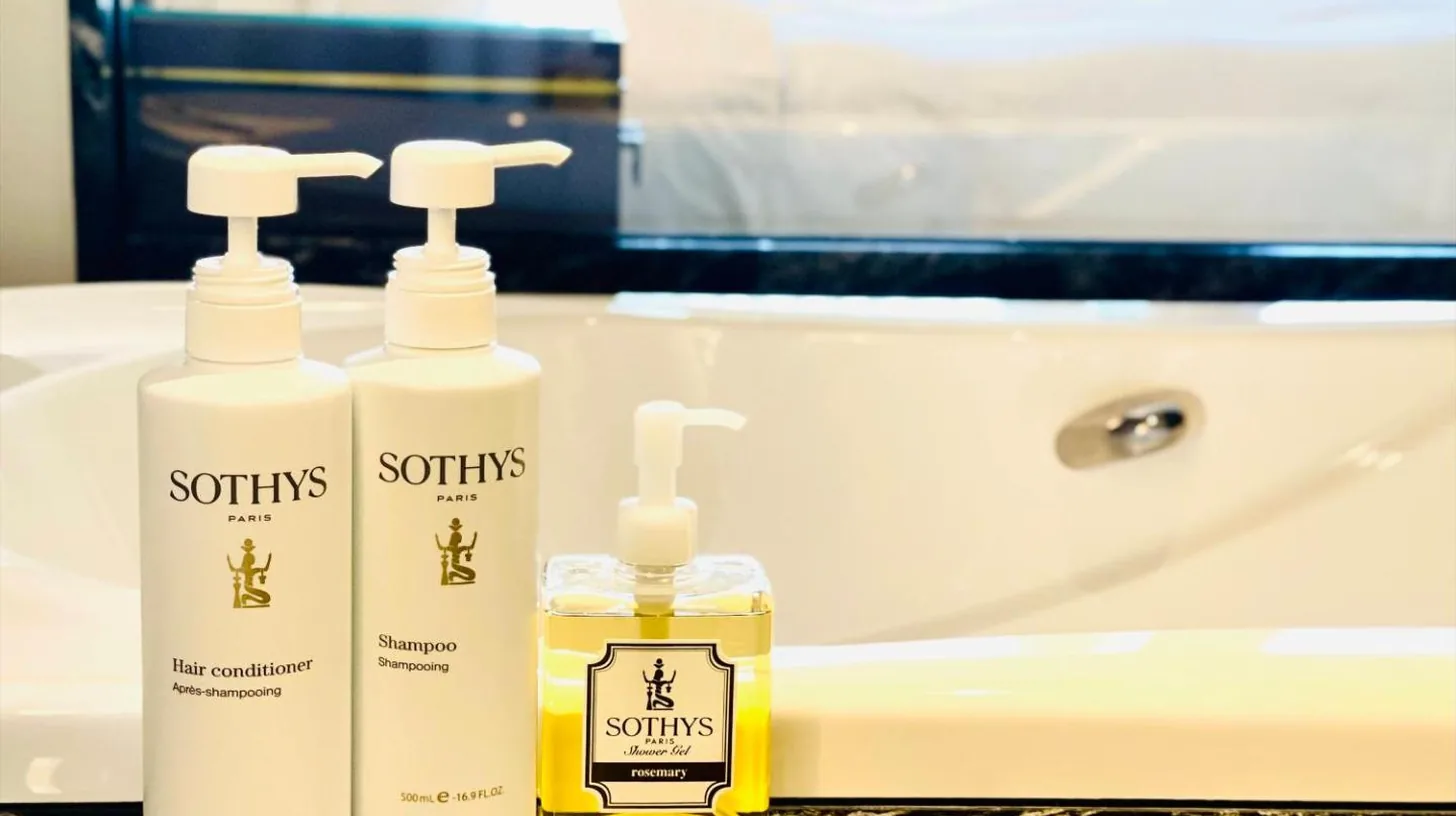 a bathroom with two bottles of soap and a sink at Okinawa EXES Naha in Naha
