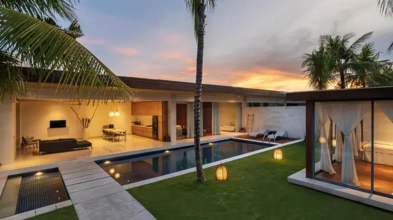 a villa with a swimming pool and a living room at One Eleven Retreat in Seminyak