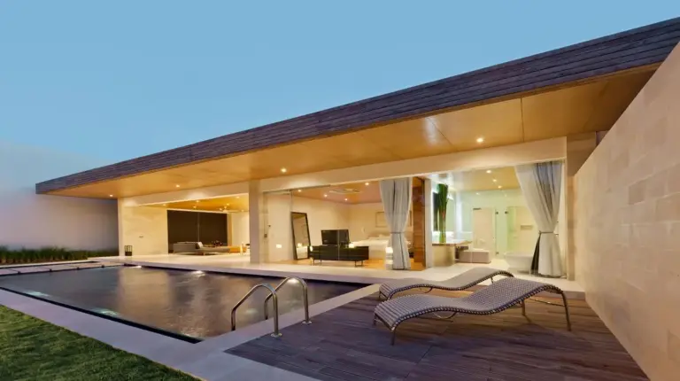 an exterior view of a house with a swimming pool at One Eleven Retreat in Seminyak