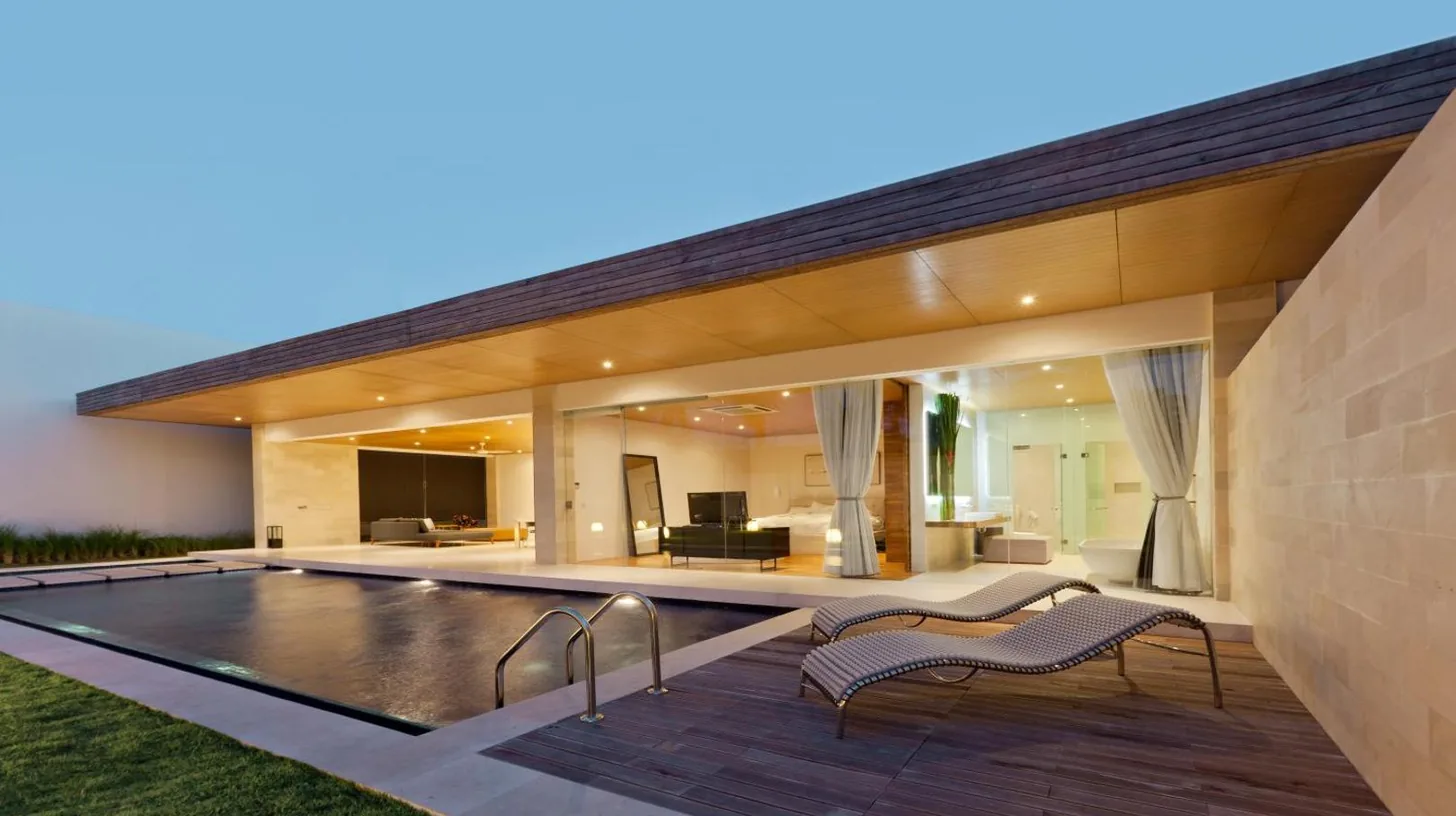 an exterior view of a house with a swimming pool at One Eleven Retreat in Seminyak