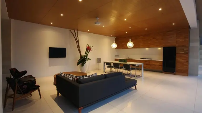 a living room with a black couch and a table at One Eleven Retreat in Seminyak